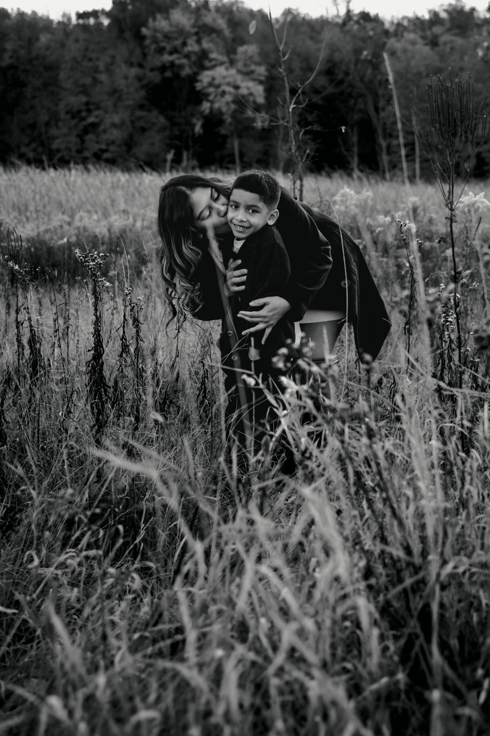 Family wearing cozy layers for winter photos in Troy Ohio