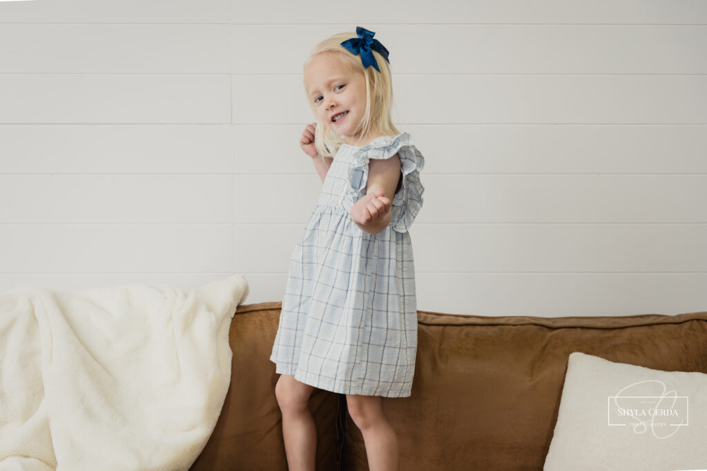 Young girl looking at the camera during a studio portrait session with Troy Ohio family photographer Shyla Cerda